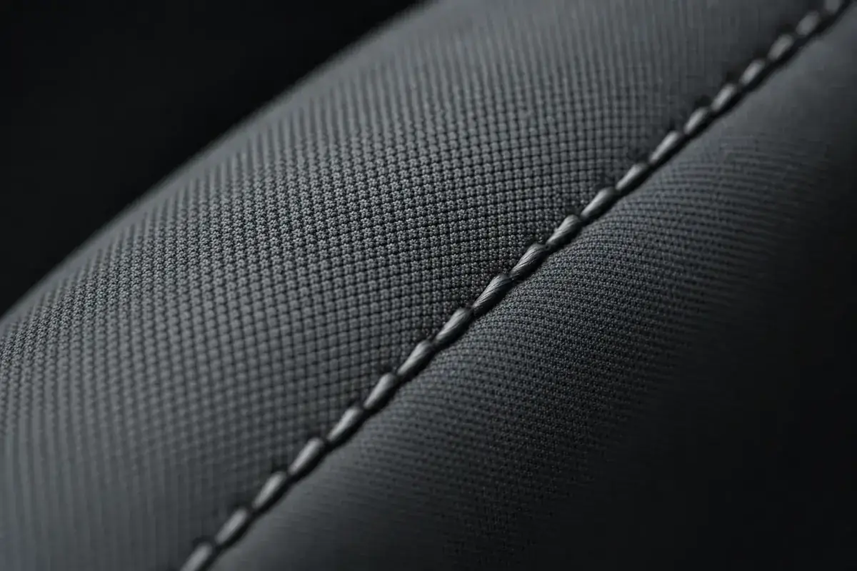 Macro detail of clean automotive seat fabric and stitching